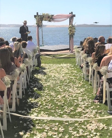 Wedding Ceremony Arch with Fabric Draping, aisle petals, aisle bouquets
