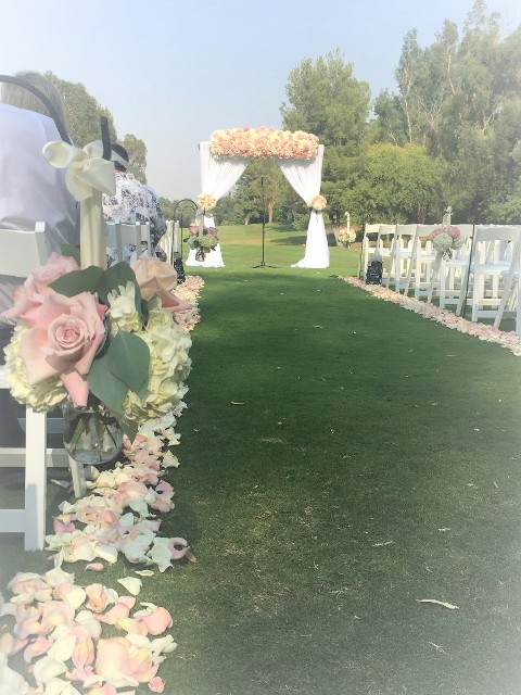 Valencia Country Club Wedding Ceremony. Fabric arch with hydrangeas and roses, aisle petals and aisle bouquets. 