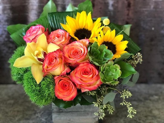 Sun Flowers, succulents, high end floral design, yellow orchids, orange roses