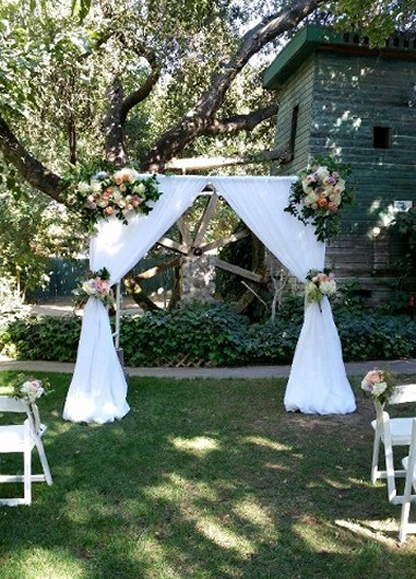 Wedding Fabric Draping and Flowers on the arch at Le Chene