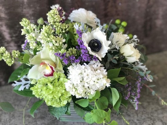 Metal Square Tin with realxed and loose flower arrangement in greens, purples and whites. 