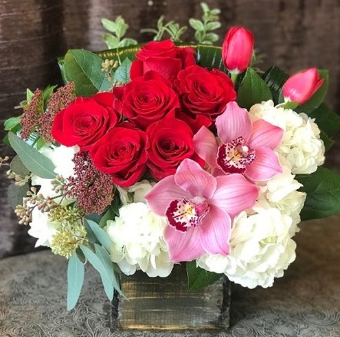 Red roses arranged in rustic wood box